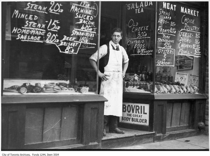 Item consists of one photograph. The location is a butcher's on Bloor St. West near Brunswick, called either Flanagan's or the Brunswick Meat Store. It may have been the second of two butcher shops with the same owner.