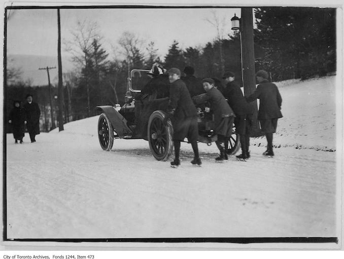Boys in skates being pulled by car, High Park. - 1908