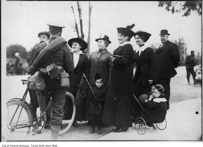 Soldier with family. - [1914?]. A note says that the location is the city limits of Hamilton, where soldiers on a trek were met by their families. (However, the soldier shown has a bicycle.) - Vintage Bicycle Photographs