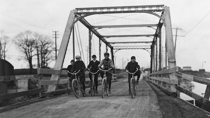 Boys cycling across Lakeshore Road bridge at Mimico. - [1907?]