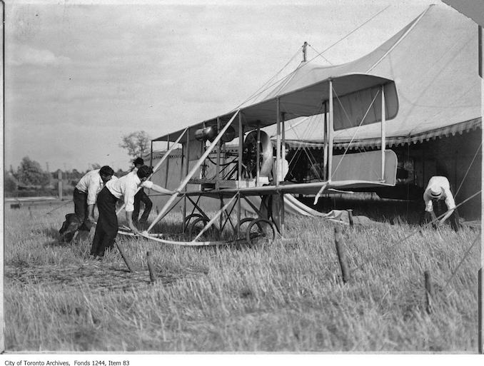 J.A.D. McCurdy's bi-plane with 7-cylinder Gnome rotary engine, and that the event is probably either the Aviation Meet held at Donlands Farm, Todmorden Mills, August 3-5, 1911, or the Aviation Meet, Hamilton, July 27-29, 1911 - Vintage Airplane Photographs