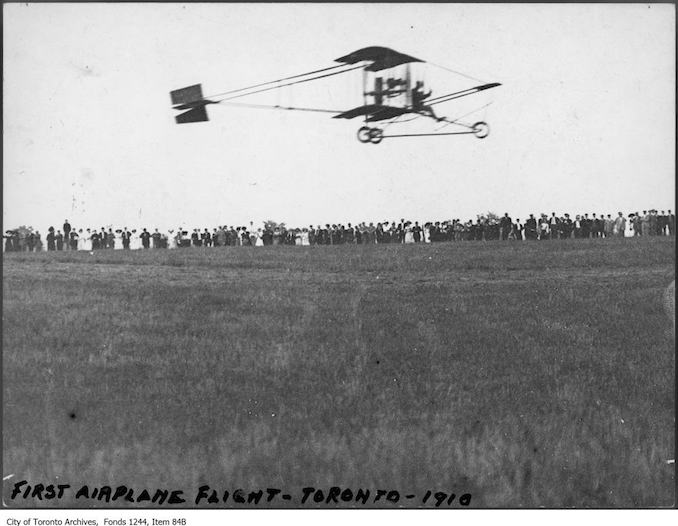 Airplane taking off. - 1910 - photograph of an airplane taking off. Information provided by a researcher indicates that the airplane is probably a Curtiss-type Pusher bi-plane with inset ailerons and rotary engine, flown by Charles F. Willard, and that the event is probably either the Aviation Meet held at Donlands Farm, Todmorden Mills, August 3-5, 1911, or the Aviation Meet, Hamilton, July 27-29, 1911.