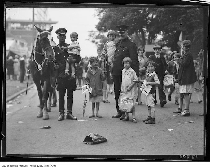 CNE, Kids Day, mounted officer and foot constable with lost kids. - August 27, 1929