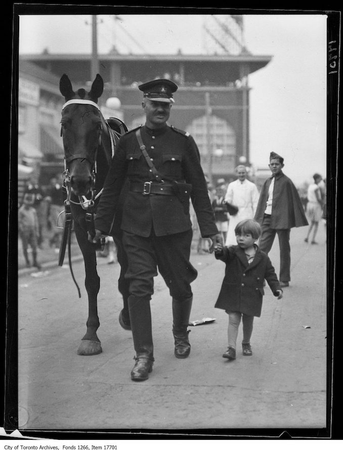 CNE, Kids Day, mounted officer with lost kid. - August 27, 1929