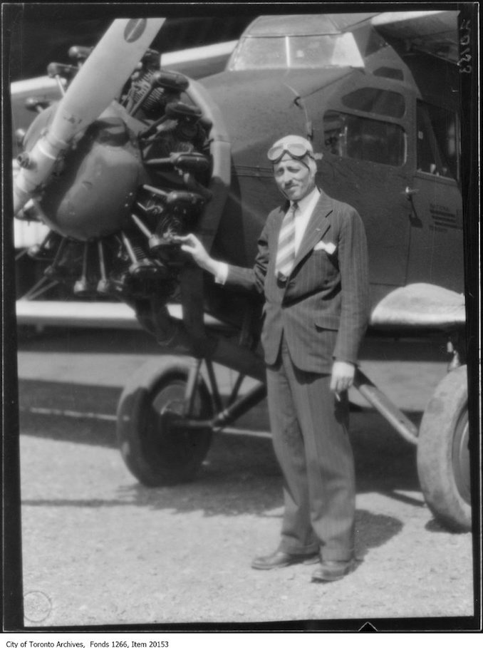 Captain Earl Hand in front of plane, close. - May 8, 1930