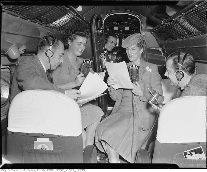 Clare Wallace and group broadcasting from inside Trans-Canada Airlines airplane