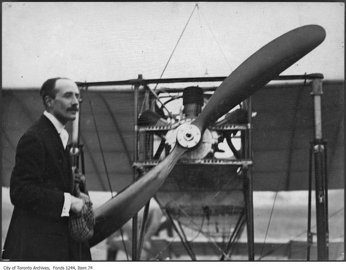 Count Jacques de Lesseps with plane . - 1910 - photograph of a man standing in front of an airplane. Information provided by a researcher indicates that the airplane is probably a Bleriot IX mono-plane with 3-cylinder Anzani engine, named Scarabee, and that the event is probably the Ontario Motor League Aviation Meet held at Trethewey Model Farm, Weston, July 8-16, 1910.