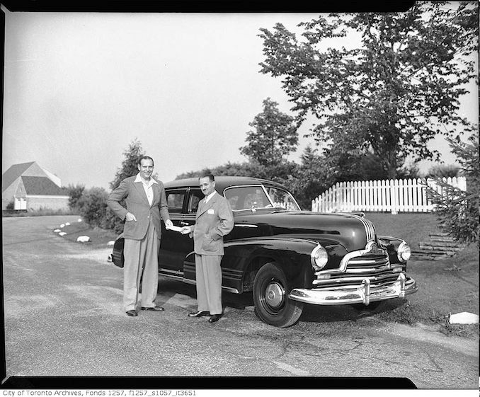 Denton Massey with unidentified man and automobile 194?