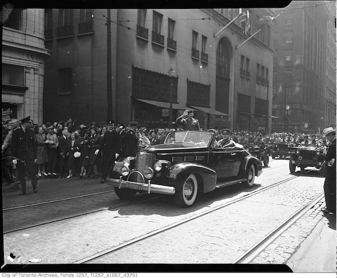 General Montgomery saluting crowds from automobile on Bay Street on the way to Old City Hall aug 31 1946