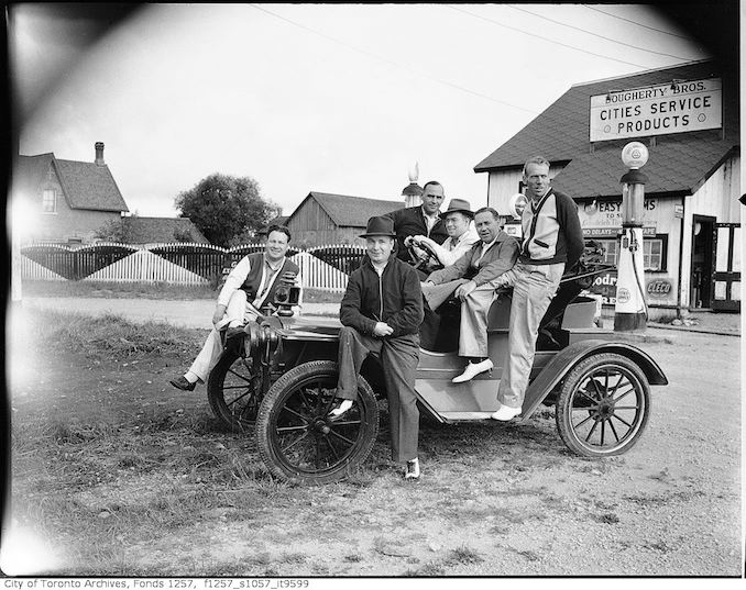 Group in old automobile, Dougherty Bros. service station, French River 194?