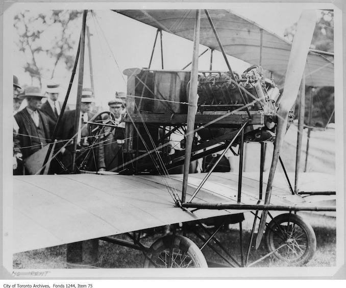 Lincoln Beachey's airplane. - 1910 - photograph of men examining an airplane. Information provided by a researcher indicates that the airplane is probably Lincoln Beachey's Curtiss-type Pusher bi-plane with 8-cylinder Curtiss V-8 engine and no forward control surfaces, and that the event is probably the Buffalo Aero Club Aviation Meet, Fort Erie, Ontario, June 20-24, 1911.