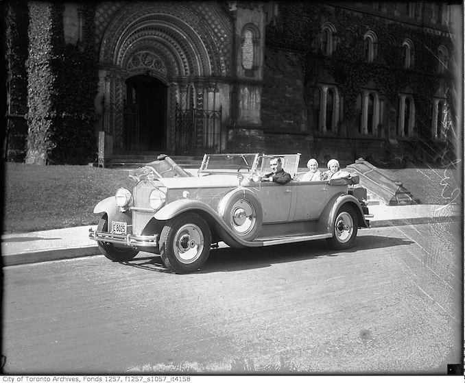 Man (Robinson?) and two women in automobile in front of University College 1931