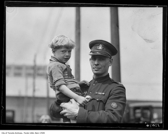 Motor League picnic to kids, patrol, Sergeant Dunn with boy. - June 24, 1929