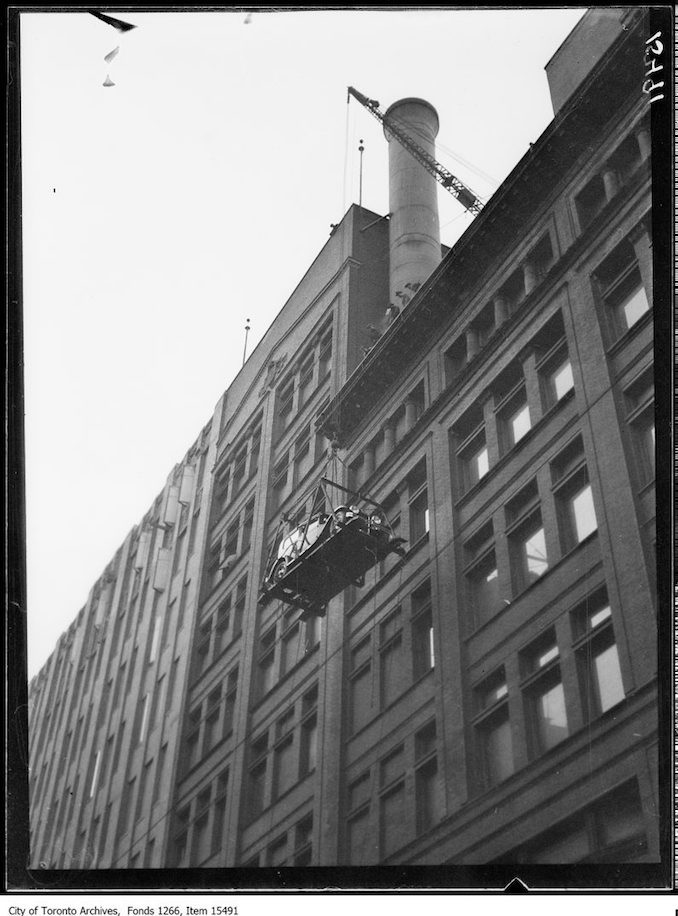 Motor Show, first car being hoisted, side, Simpson Bldg. - January 4, 1929