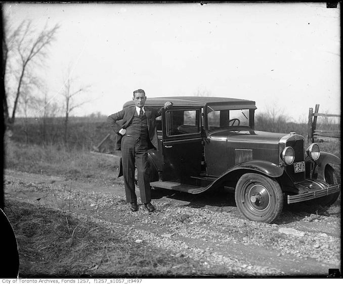 Nat Turofsky next to automobile 1930