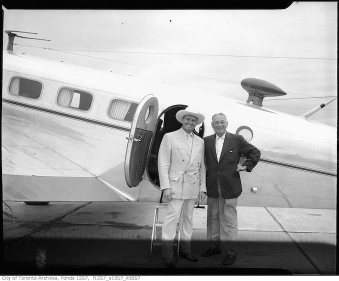 Nat Turofsky (right) next to airplane