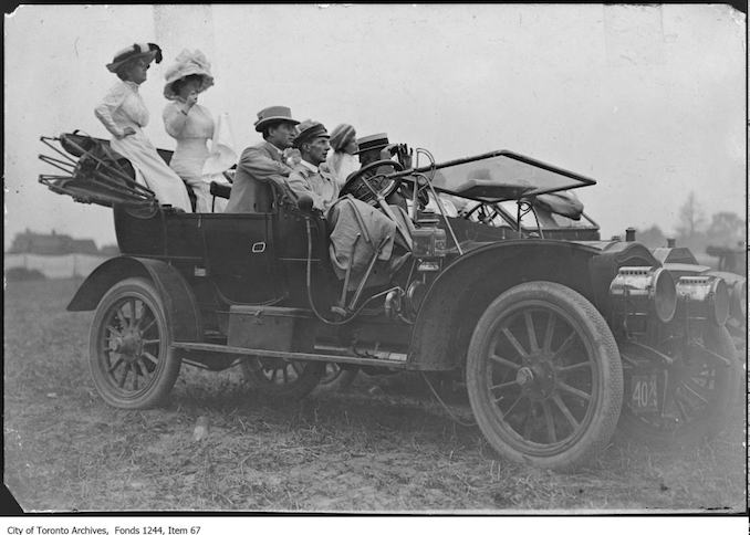 People in automobile watching first airplane flight, Weston. - July, 1910