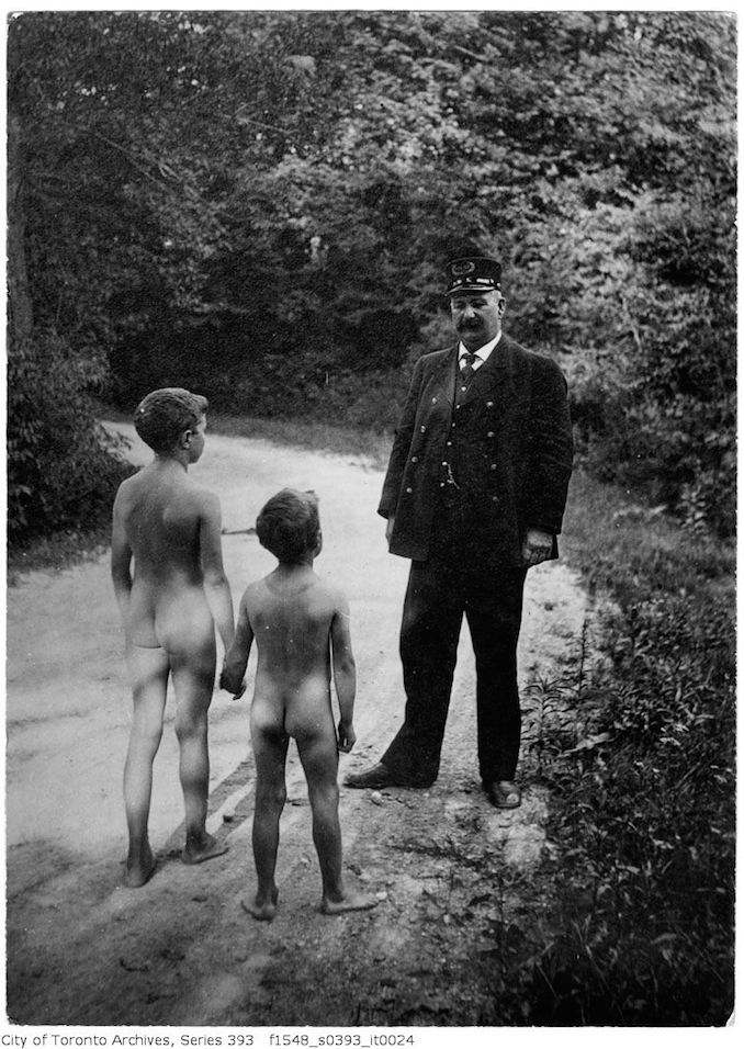 Police officer and (naked) boys on road