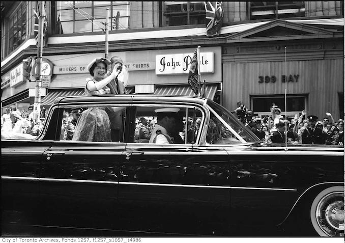 Queen Elizabeth II in automobile, moving past spectators on Bay Street 1959