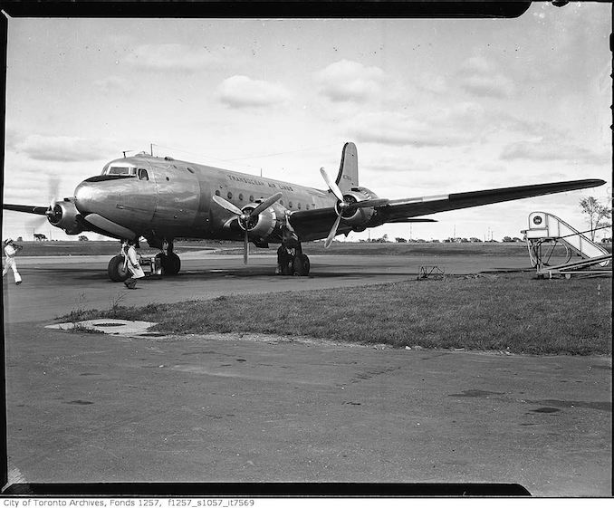 TCA Trans Ocean Airlines airplane carrying immigrants on runway, Malton airport