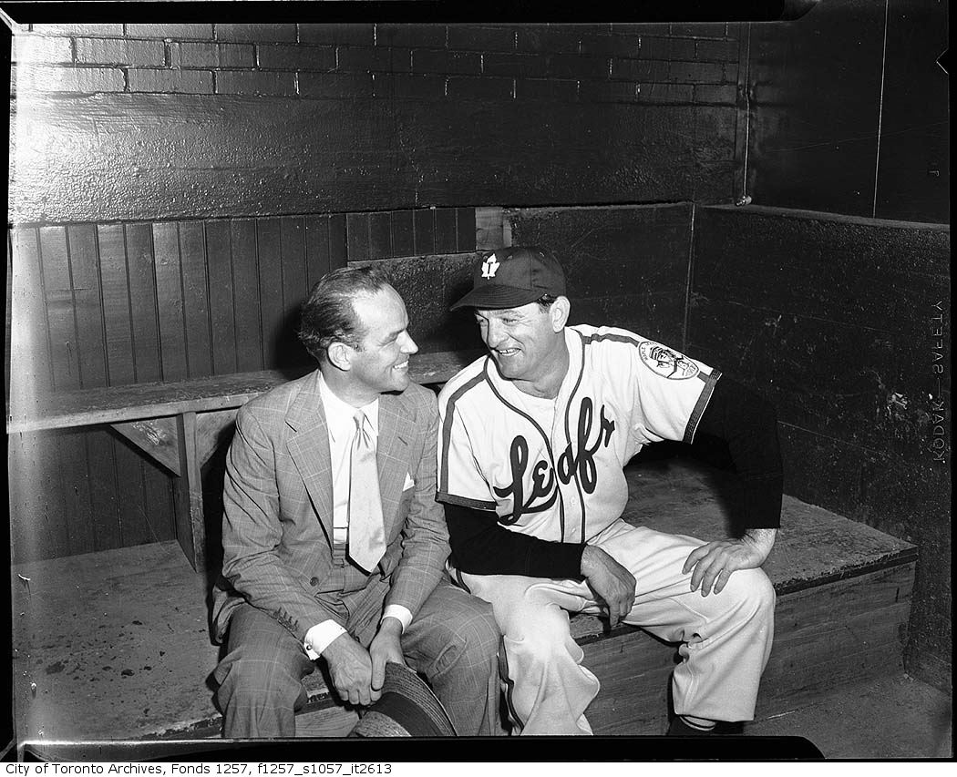 Jack Kent Cooke with baseball player in Toronto Maple Leafs Baseball Club dugout, Maple Leaf Stadium 195?