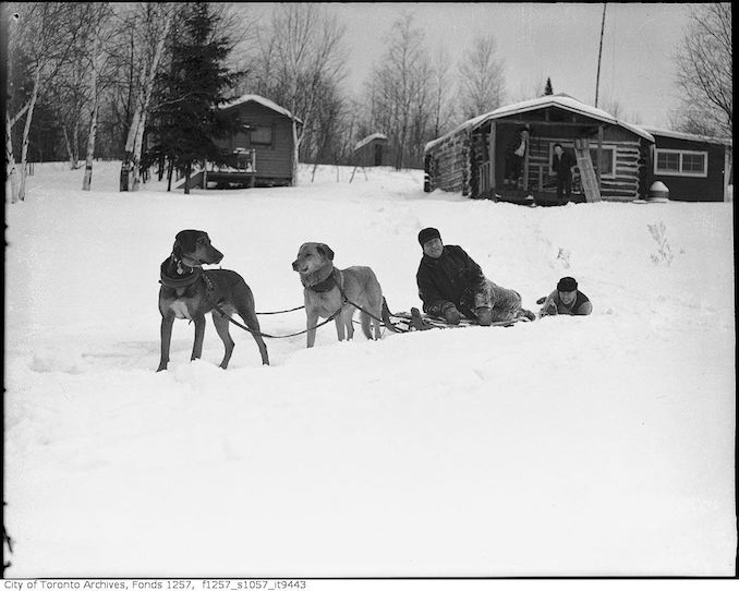 Lou Turofsky near cabin in woods 193?