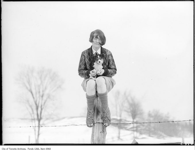 Ski-ing, girl with dog seated on post. - January 17, 1926 - Vintage Animal Photographs