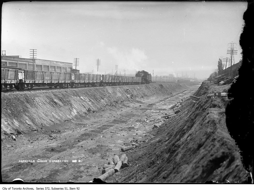 Train of cars, looking northeast (east of Dufferin). - June 8, 1911