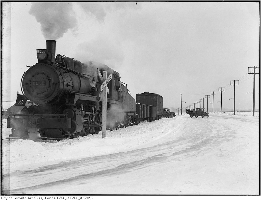 Truck stalled by freight train, Keating St - Dec 29 1933