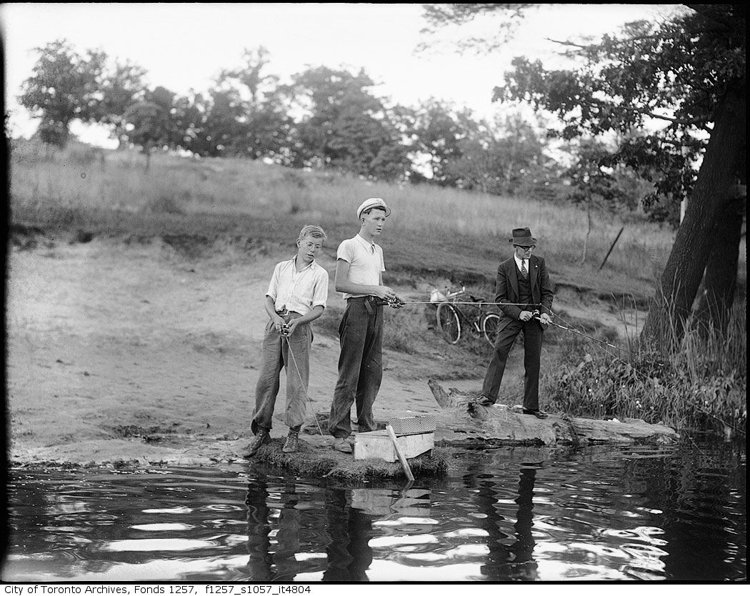 1980s Boy Fishing On Riverbank by Vintage Images