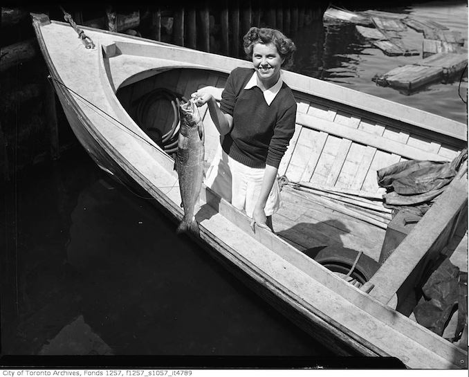 194? - Woman in boat, holding fish - vintage boating photographs