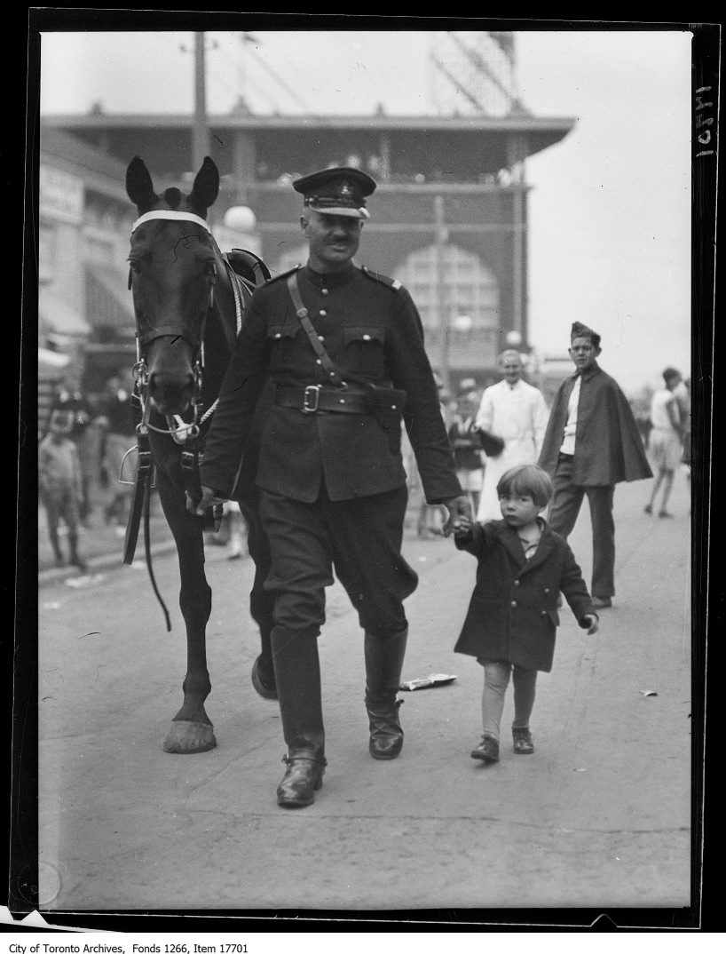 1929 - CNE, Kids Day, mounted officer with lost kid