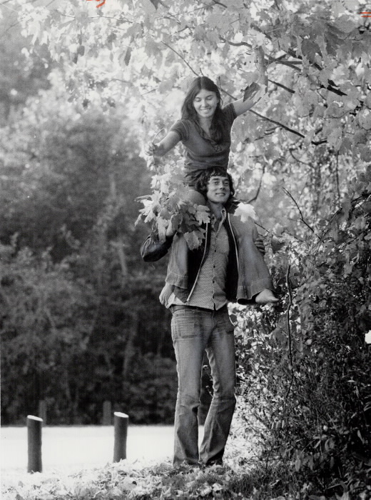 1973 - Collecting autumn leaves in Morningside Park, 21-year-old Beth Lamb rides on the shoulders of Robert Kalisz, also 21 - Vintage Autumn Photographs