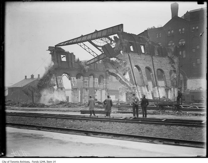 1907 - Men viewing the demolition of fire remains at site of future Union Station.