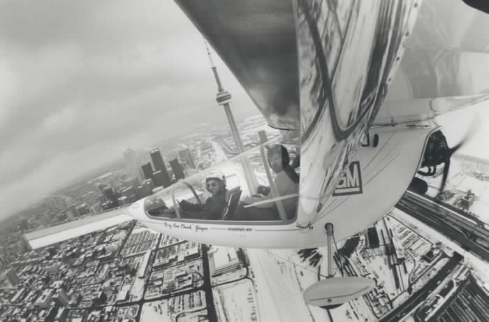 1985 - A wing-mounted camera captures this view of the Toronto skyline with pilot Larry Newman 37 left and Star photographer Mike Slaughter