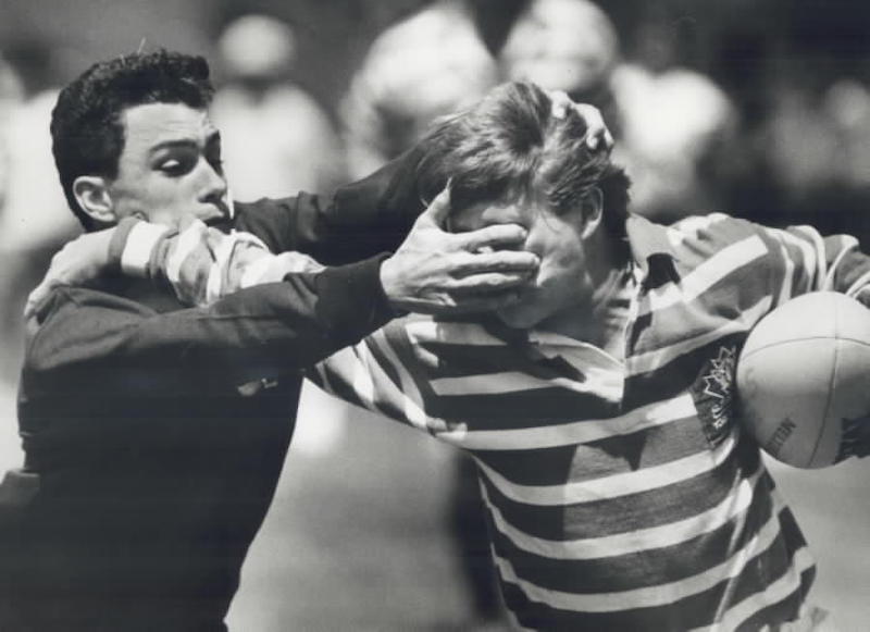 1985 - A defender from Nelson Boylen Secondary School Bullets left; determined to stop the enemy from going any farther in a North York senior rugby match by Sunnybrook Park yesterday