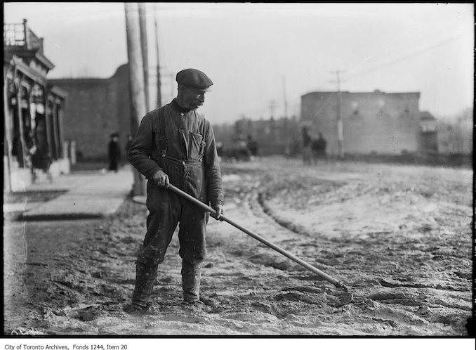 1911 - Man hoeing muddy road smooth, Yonge Street at Davisville Avenue