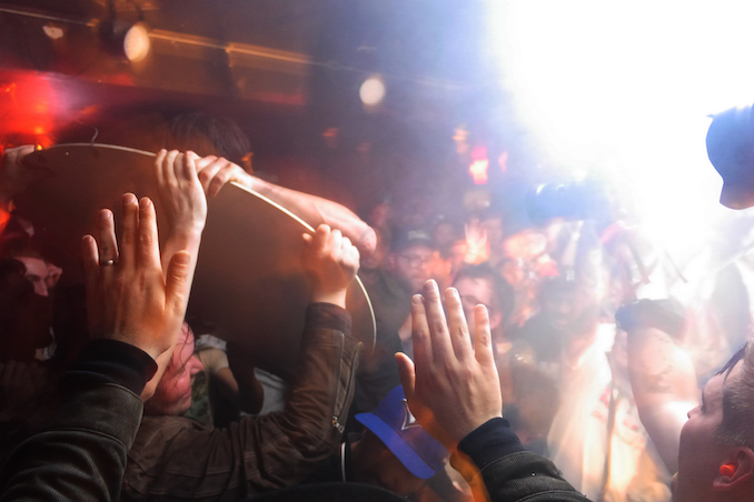 Protecting myself as a Metz fan surfs on the Silver Dollar Room stage sign