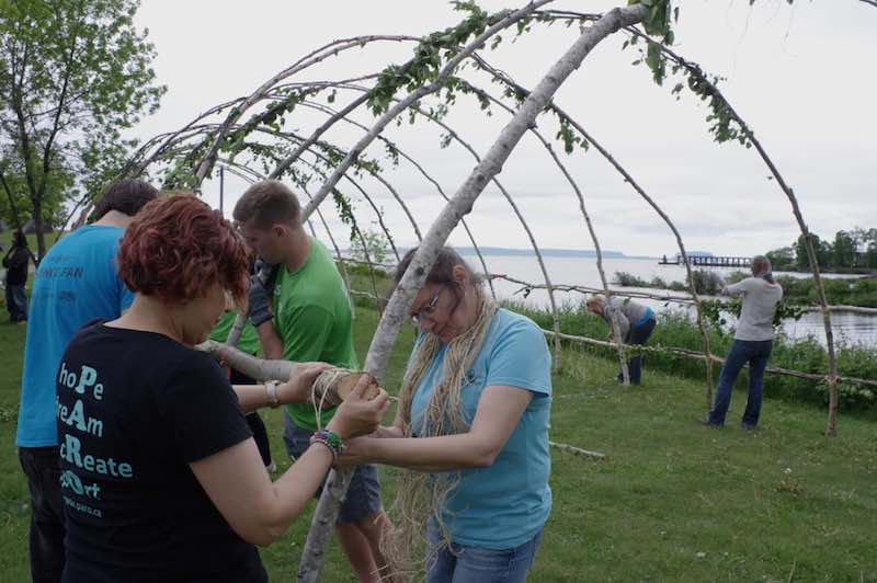 A group of volunteers work on the bracing to reinforce the 13 main arcs on the Rites of Passage teaching lodge that was set up on June 19 at the Thunder Bay waterfront for National Aboriginal Day and Canada Day - Rick Garrick - National Aboriginal Day