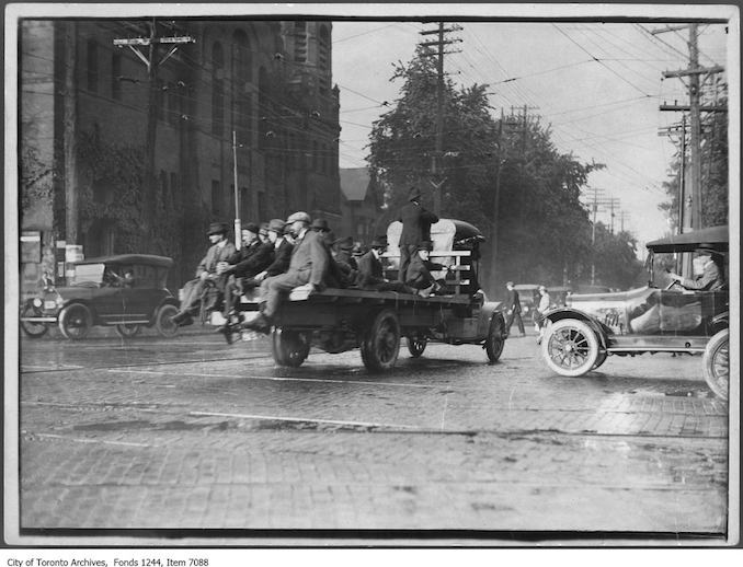 1919 - Truck carrying passengers during streetcar strike, northeast corner of College Street and Spadina Avenue