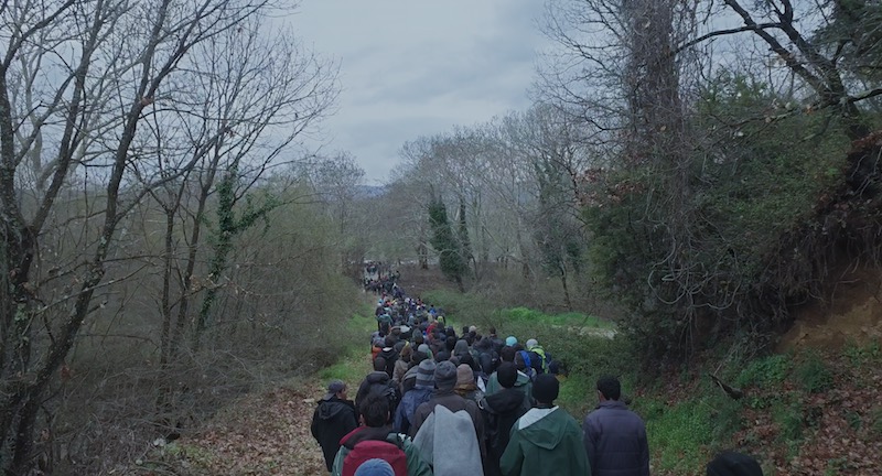 Scene from Human Flow doc, refugees walking near Idomeni Camp, Greece.