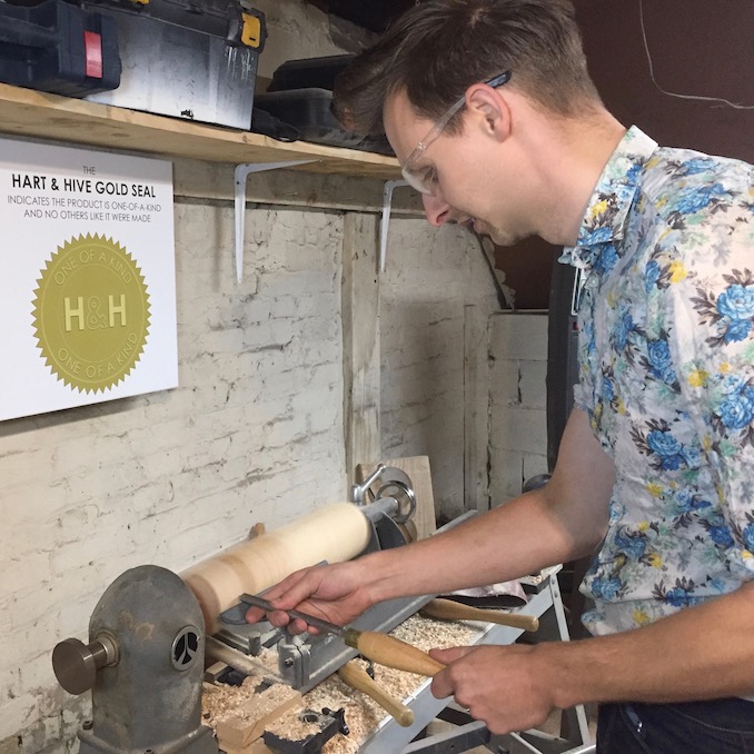 Here Thomas can be seen turning some maple legs on the lathe in his workshop. The wood was reclaimed from shipping pallets and are part of a chair he is working on. 