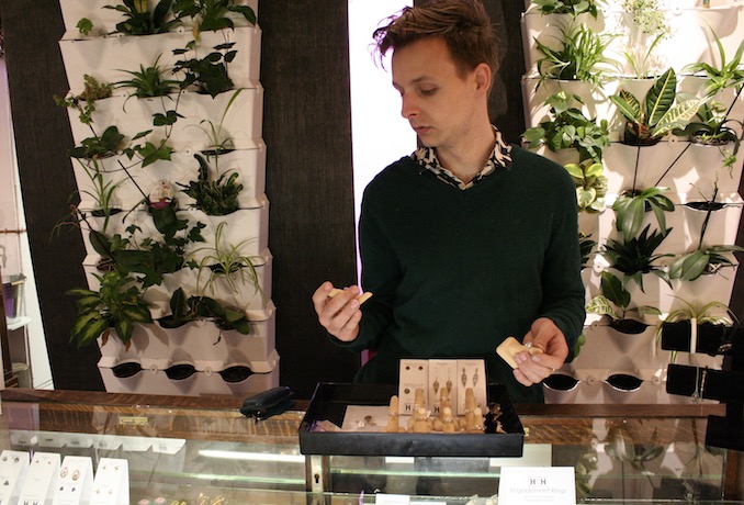 Surrounding himself with plant life is always important to Thomas and his showroom boasts two living walls (a product he also sells) Here, designer Thomas Hart, is seen inspecting some one-of-a-kind engagement rings designed in Toronto by Chancellor Jewels.