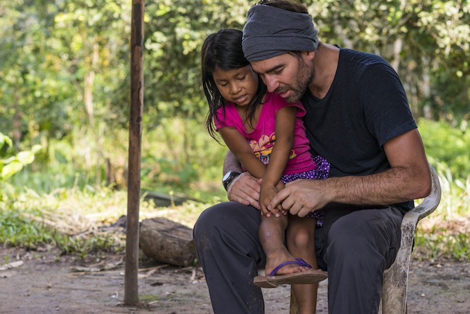 Neil Ever Osborne in the community house of Ganketa while on assignment with Audubon Magazine. Yasuni National Park, Ecuador.