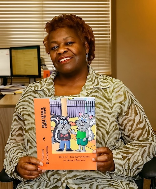 Yvonne Blackwood - Posing with my first children’s picture book, Nosey Charlie Comes To Town