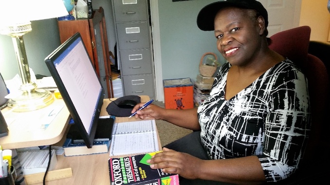 Yvonne Blackwood - Sitting at my desk in my office writing a story. I like to write my thoughts with a pen first, then I type them.