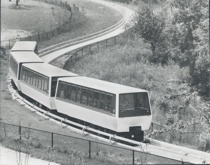 1976 - The electrically powered train travels along a concrete guideway winding through part of 410-acre Rouge River valley.