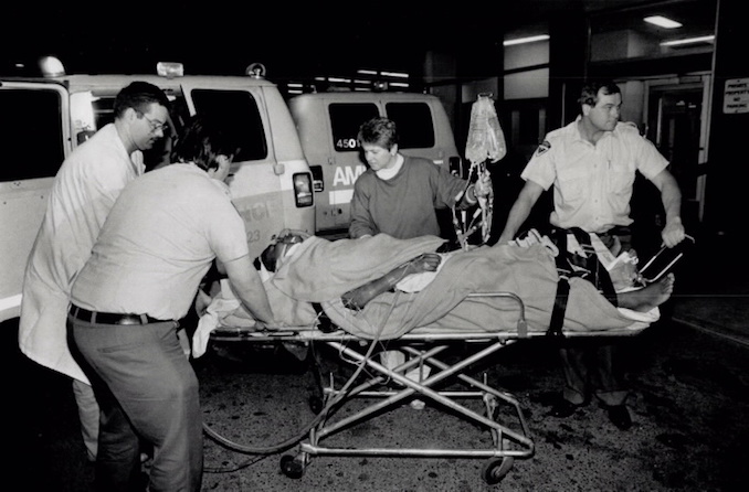 1989 - Ambulance workers, a nurse and a policeman wheel Sofia Cook, 23, of Brampton into Toronto General Hospital yesterday after she was shot by police.