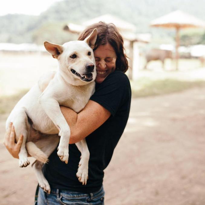 Kelly and her rescue dog Moonoi at Elephant Nature Park in Chiang Mai, Thailand.