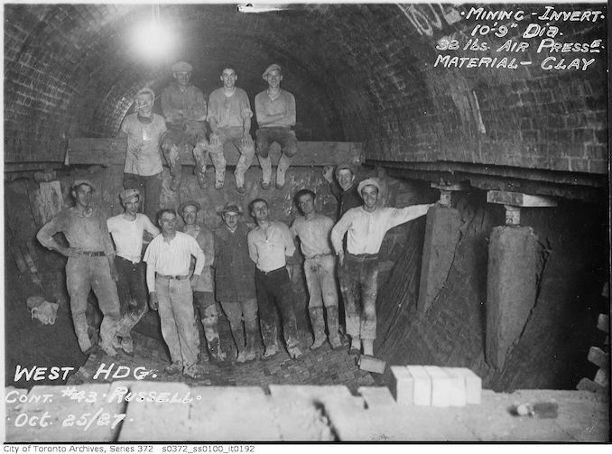 1927 - Sewer construction workers, west heading, contract 43 - Russell - mining invert, 10 feet, 9-inch diameter, 32 pounds air pressure, material clay